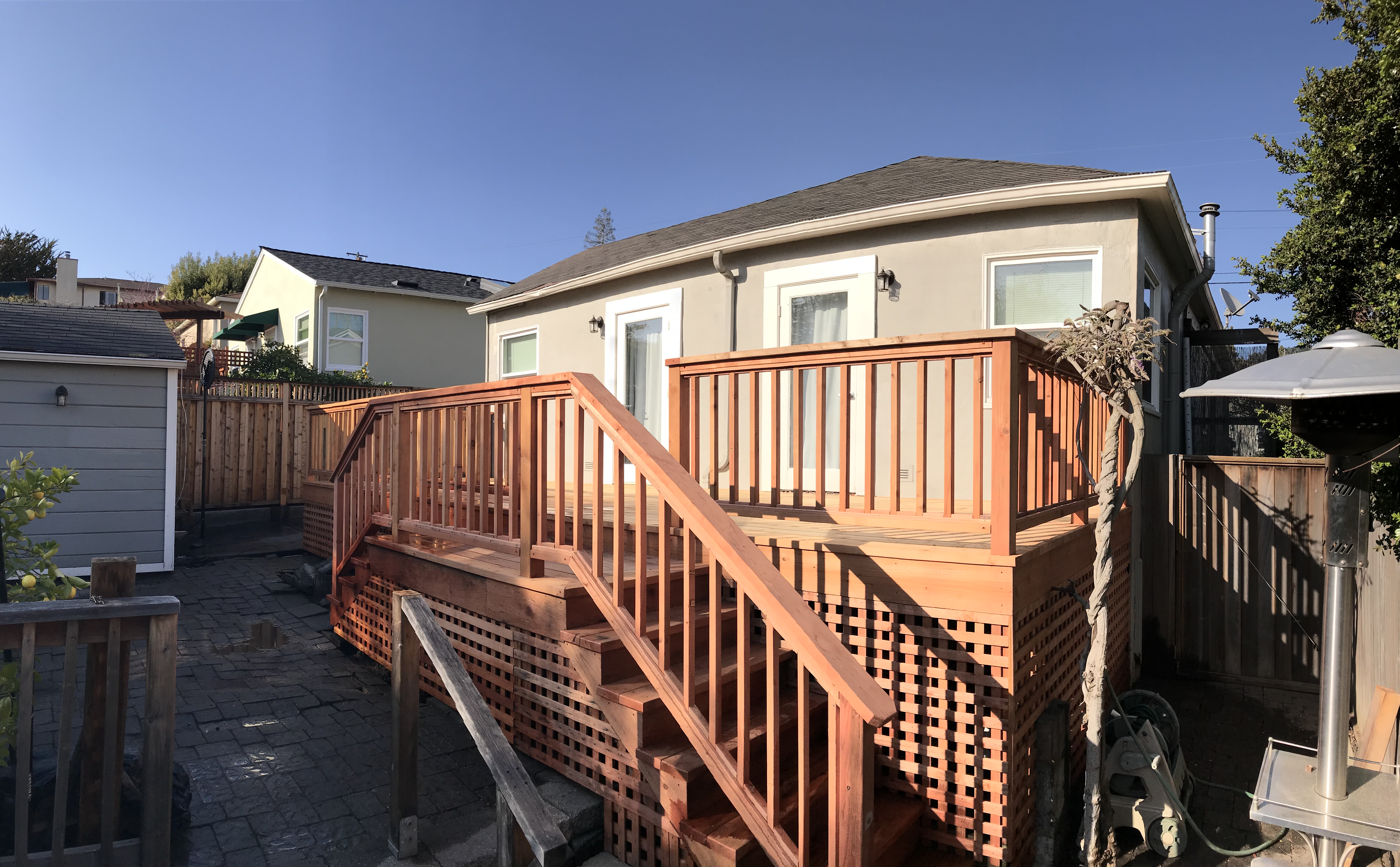 Redwood deck with stairs, railing, and lattice skirting