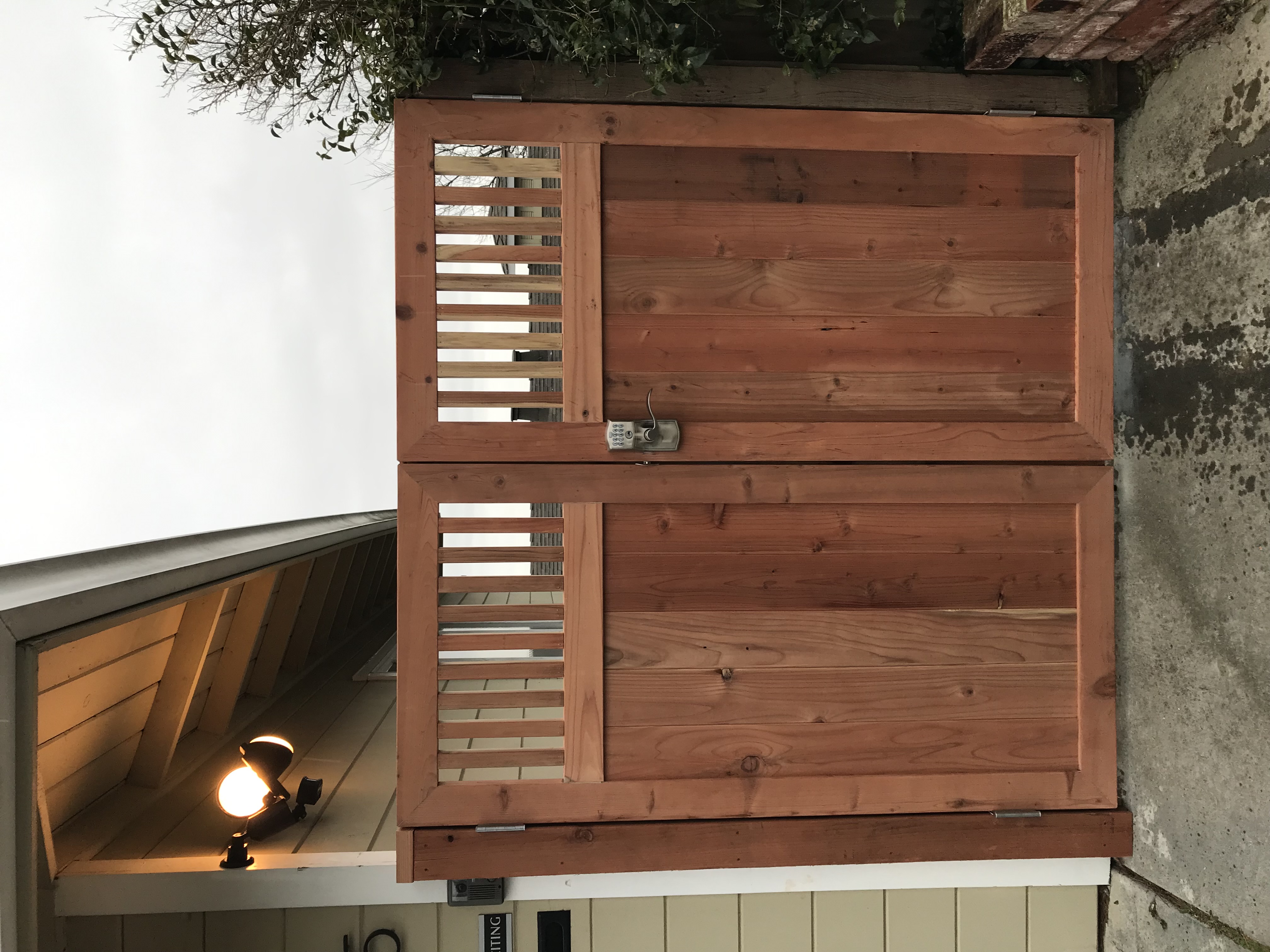 Custom cedar gate with horizontal boards and louvered top