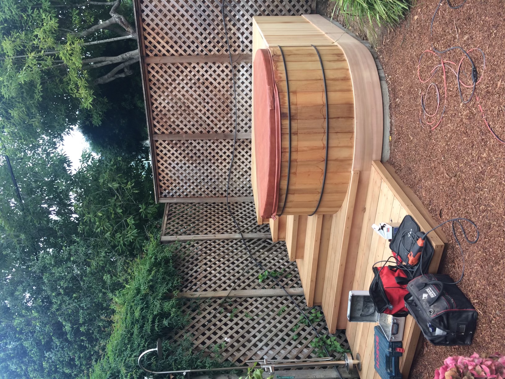 Custom cedar hot tub surround with curved deck