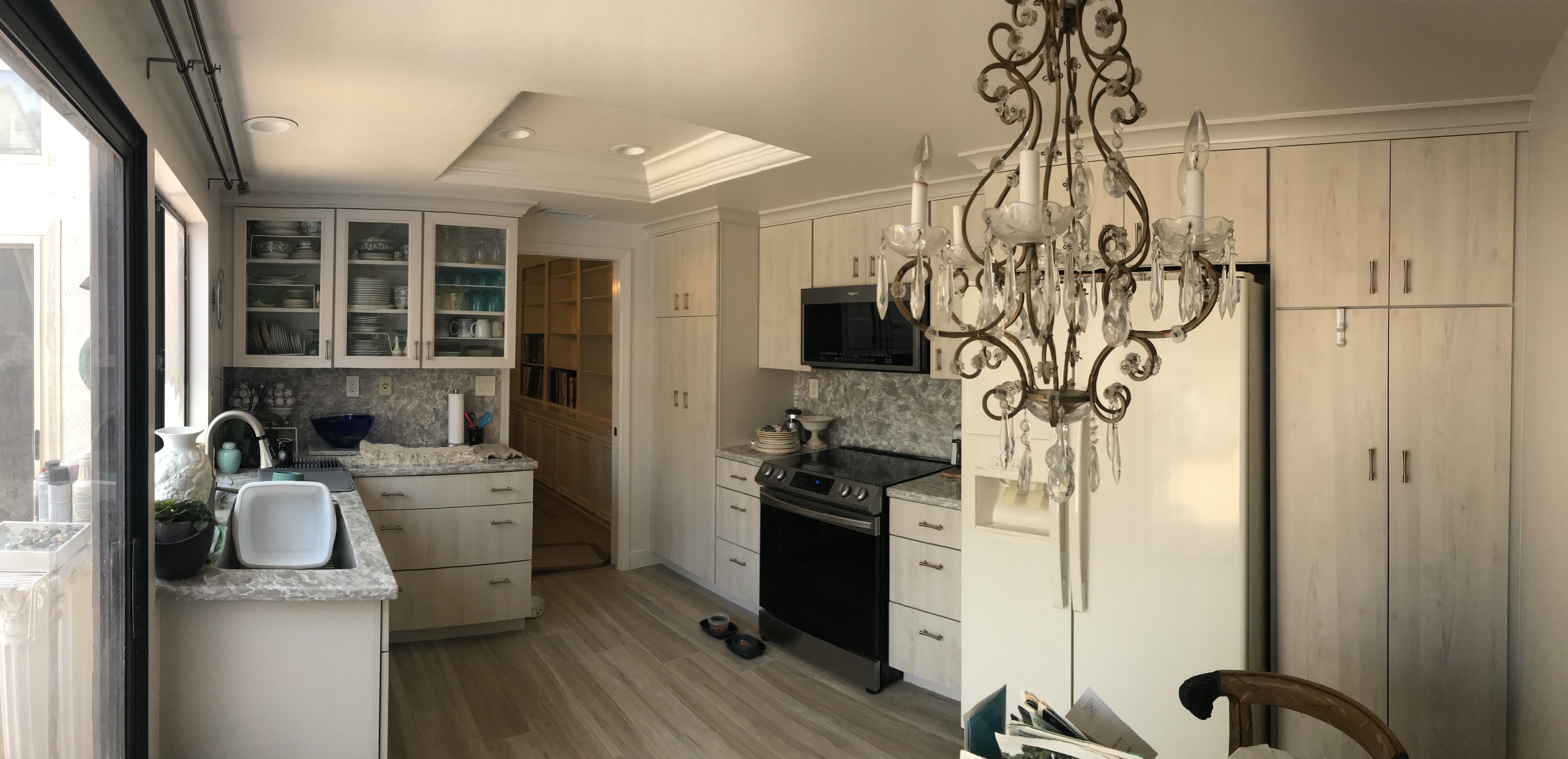 Kitchen remodel with maple cabinetry and chandelier