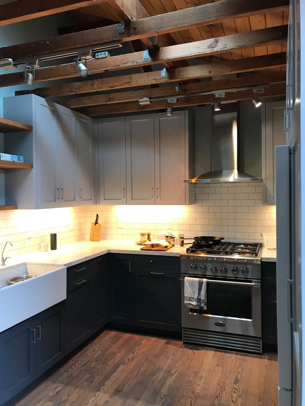 Premium kitchen remodel with custom cabinetry, exposed beams, and subway tile