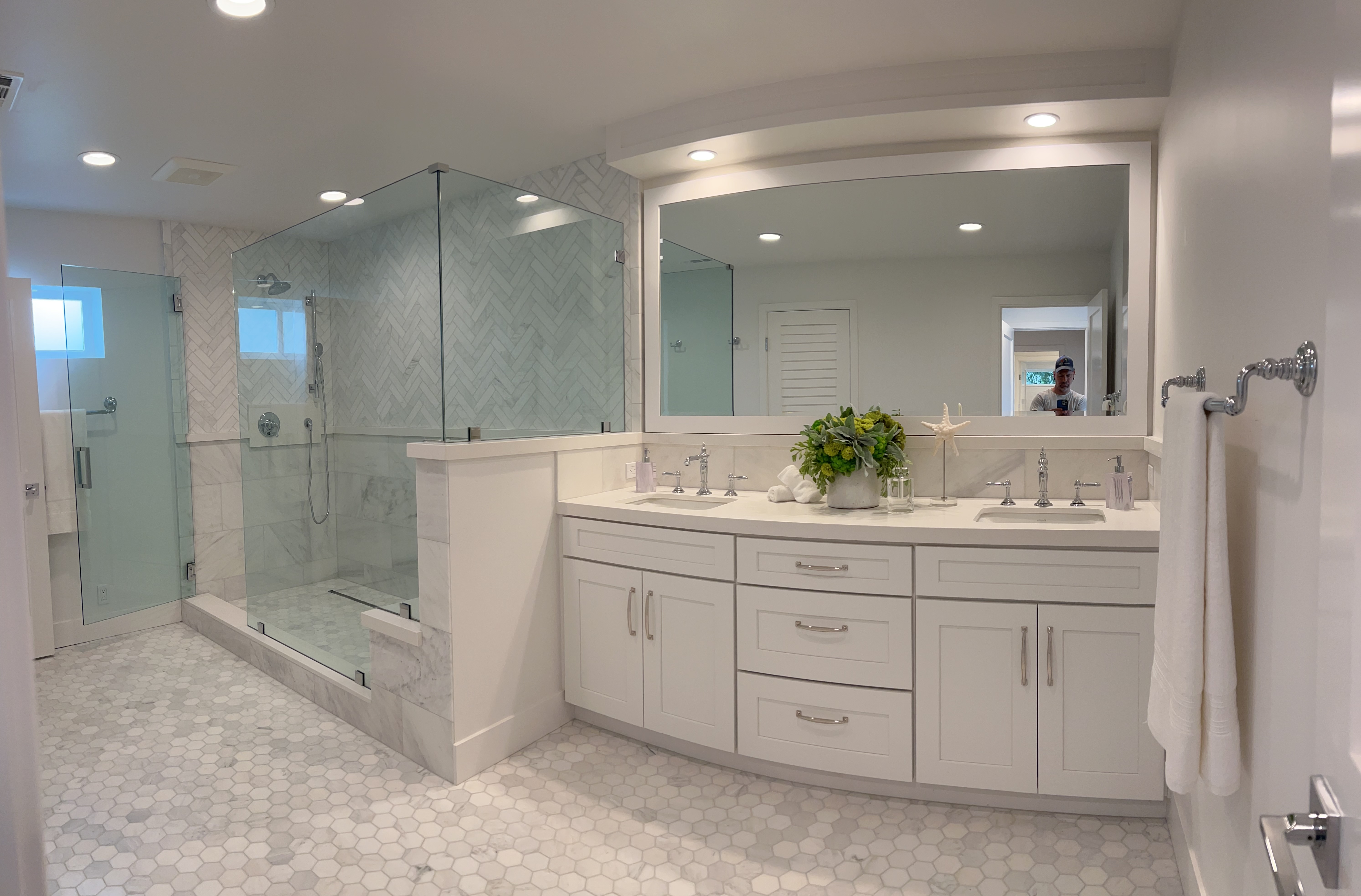 Master bathroom with white double vanity and marble hex floor