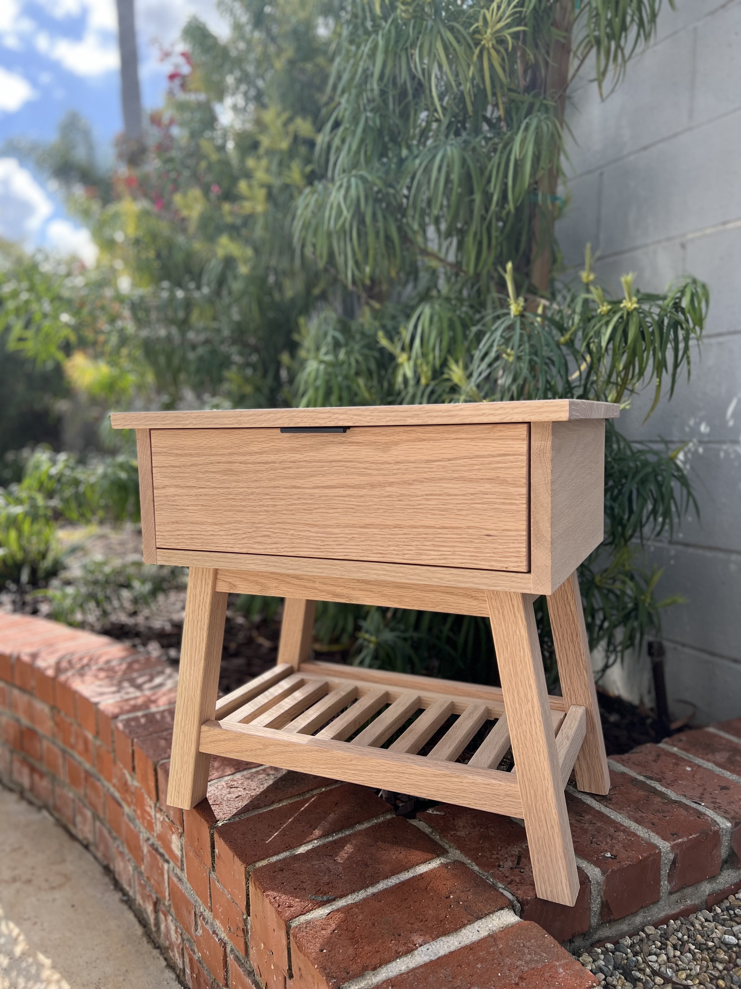 Mid-century style oak nightstand with drawer and slatted shelf