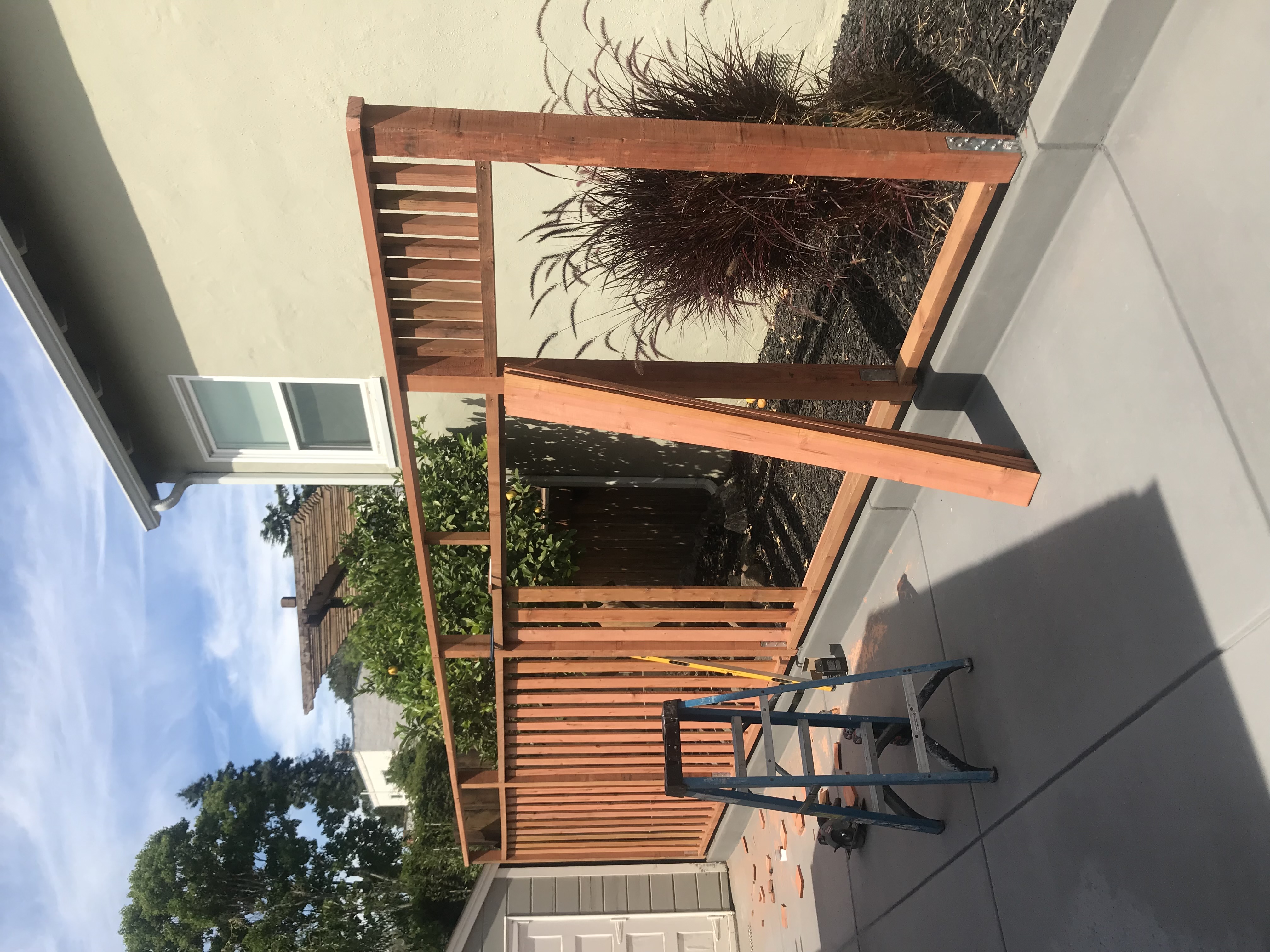 Cedar pergola with horizontal slat privacy screen
