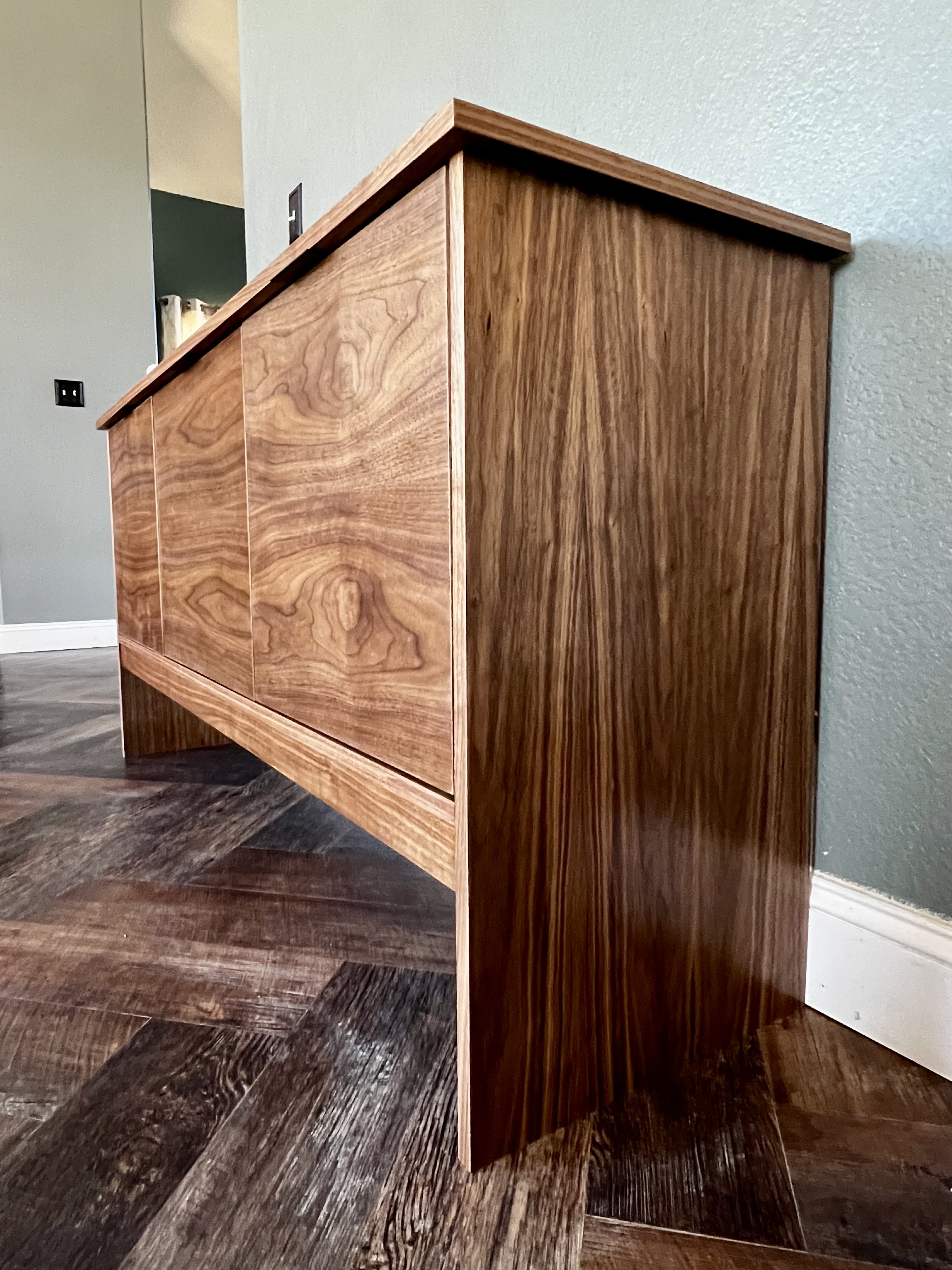Walnut credenza close-up showing grain detail and joinery
